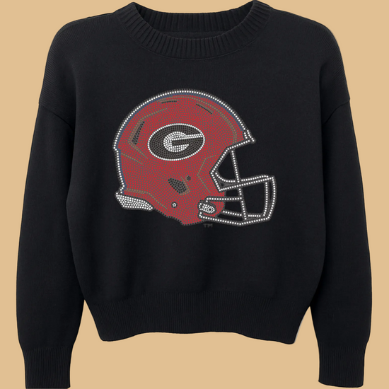 Black sweater with a red football helmet graphic on a white background