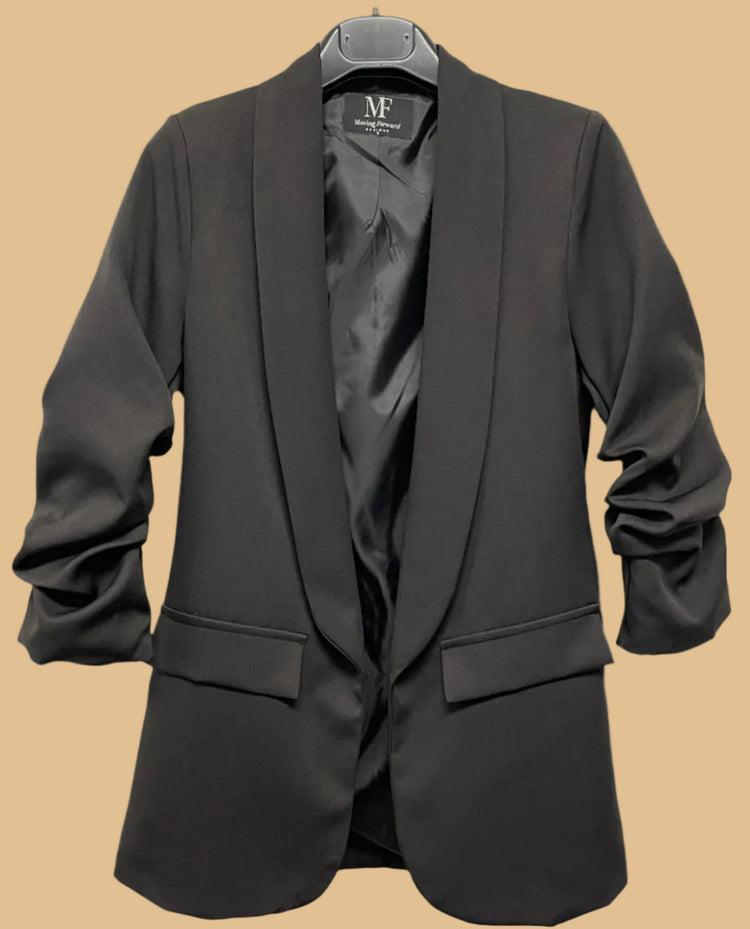 Black blazer on a hanger with a visible brand label against a white background