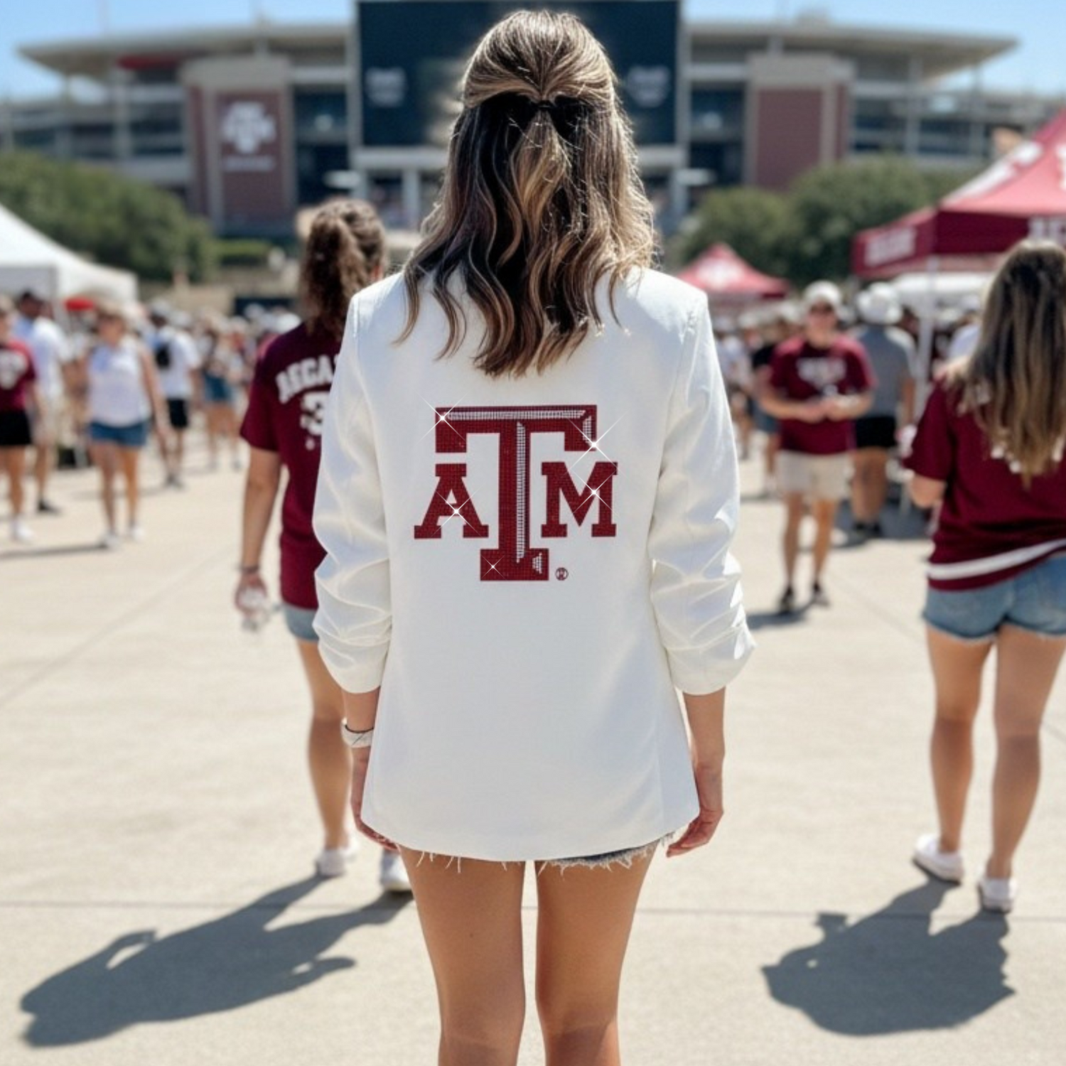 Person wearing a white sweatshirt with a red 'ATM' logo at a sports event.