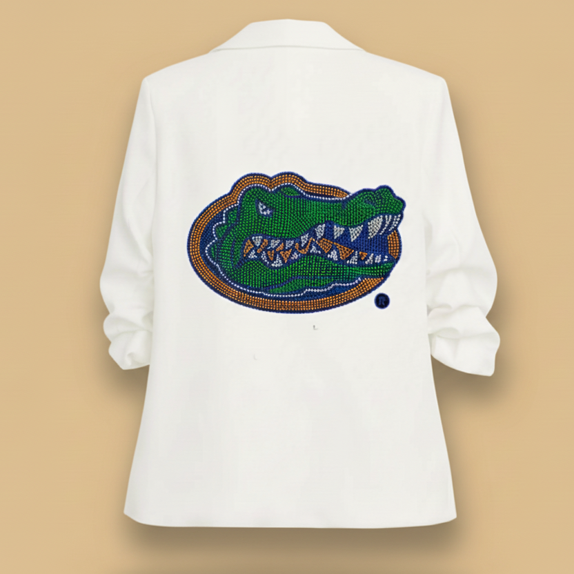 White blazer with a beaded alligator design on the back against a white background
