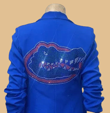 Blue jacket with a decorative emblem on a mannequin against a white background