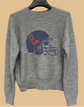 Gray sweater with Ole Miss logo on a hanger