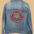 Blue denim jacket with a University of Georgia patch on a white background