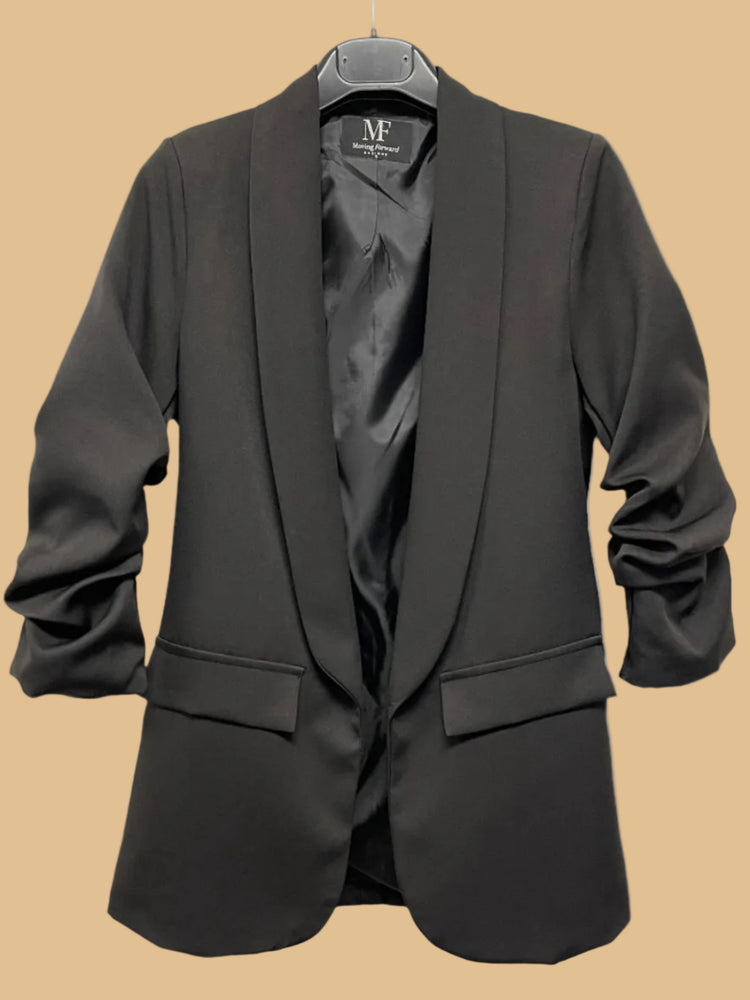 Black blazer on a hanger with a visible brand label against a white background