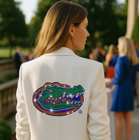 Person wearing a white blazer with a Florida Gators logo on the back, standing outdoors.