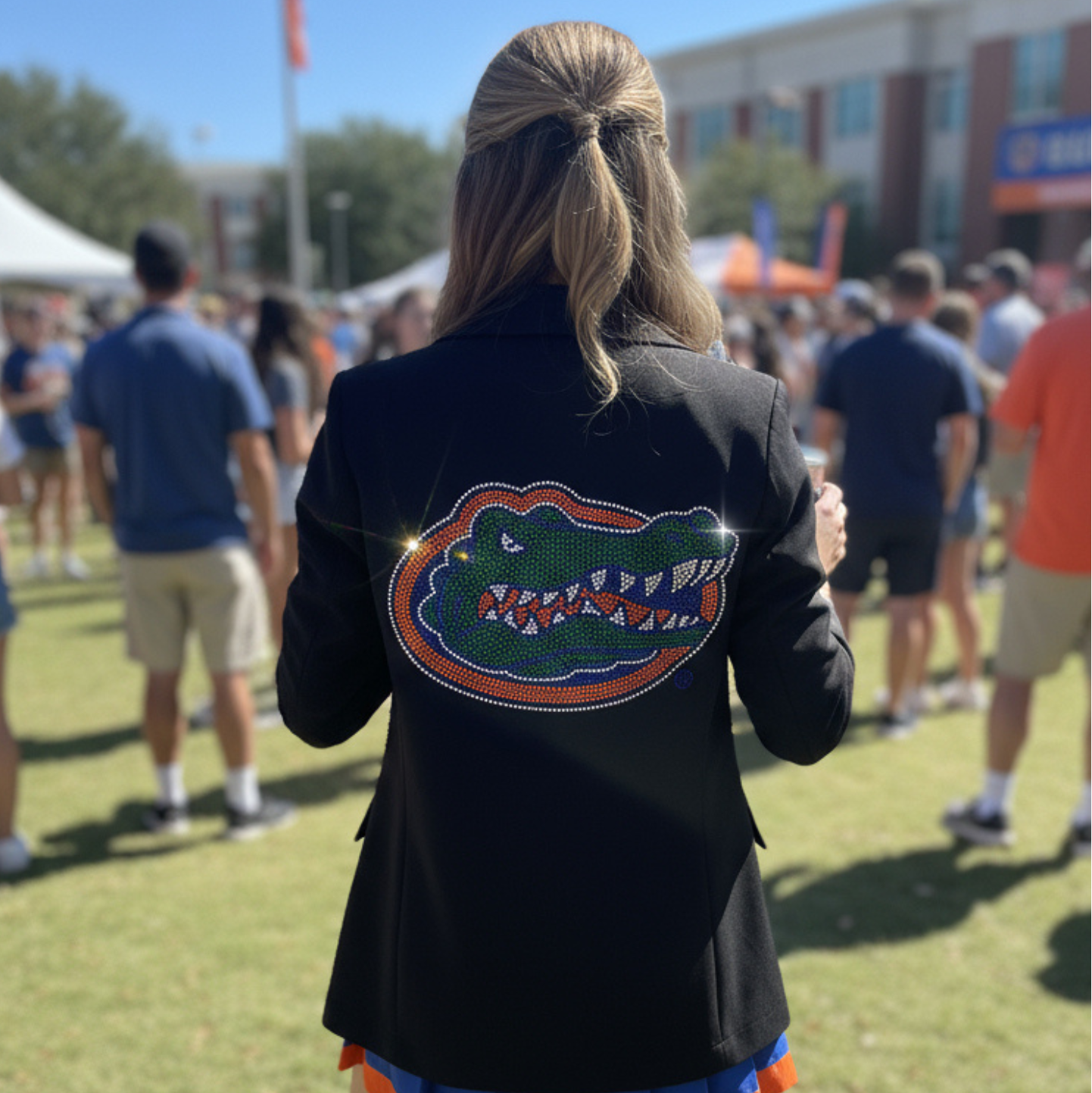 Person wearing a black jacket with a Florida Gators logo at an outdoor event.