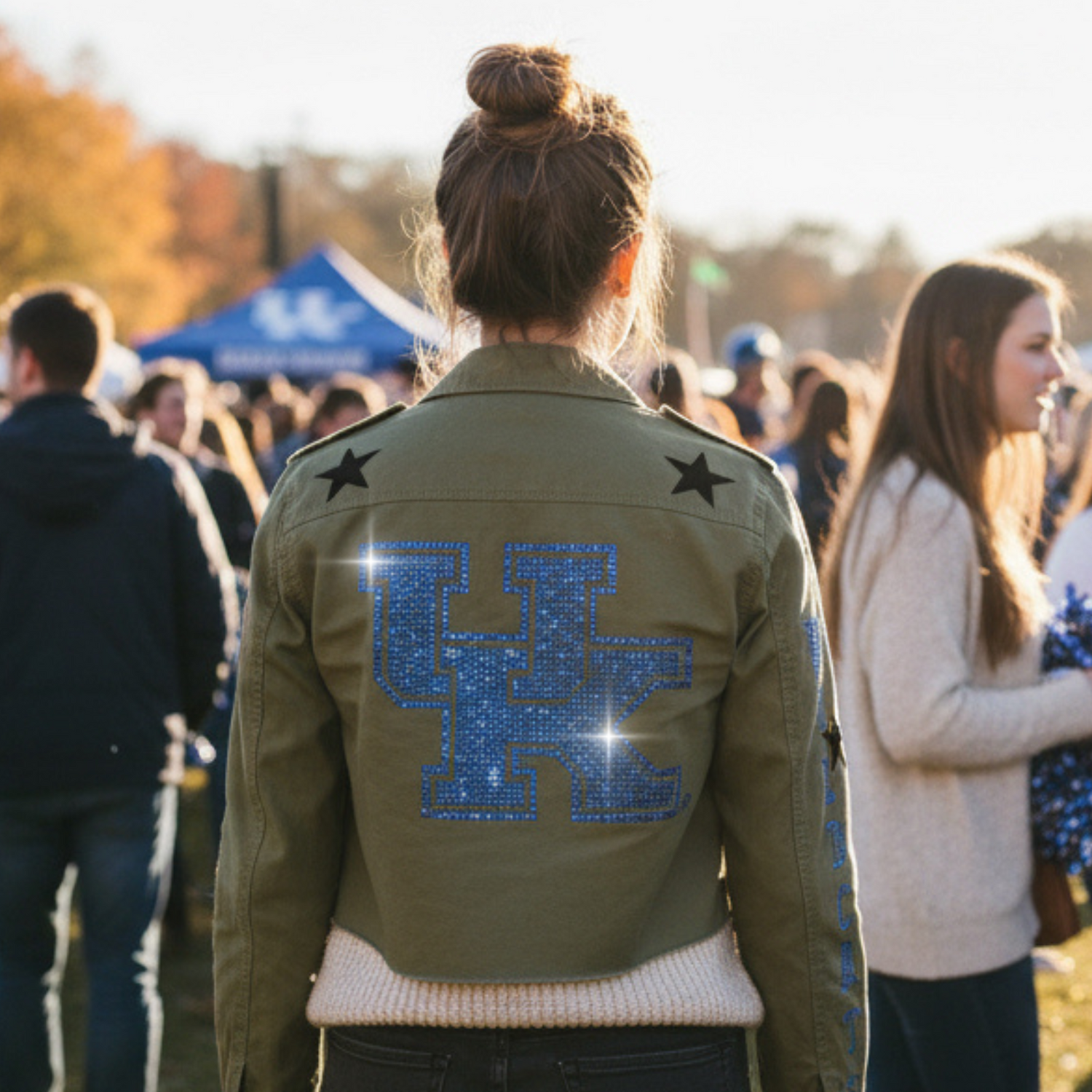 Person wearing a green jacket with &