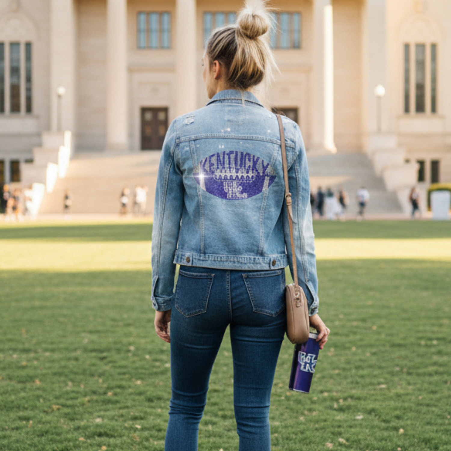 Person wearing a denim jacket with &