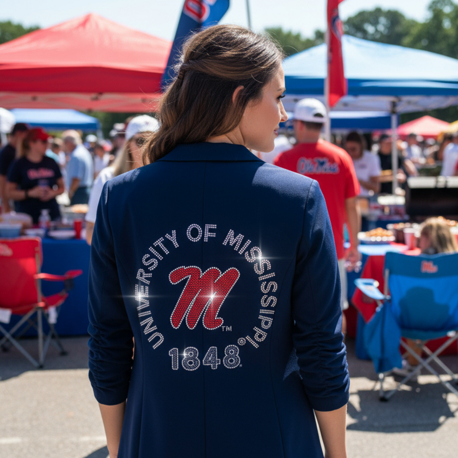 Person wearing a navy blue jacket with &