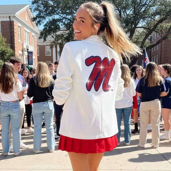 Woman in a white jacket with a red &