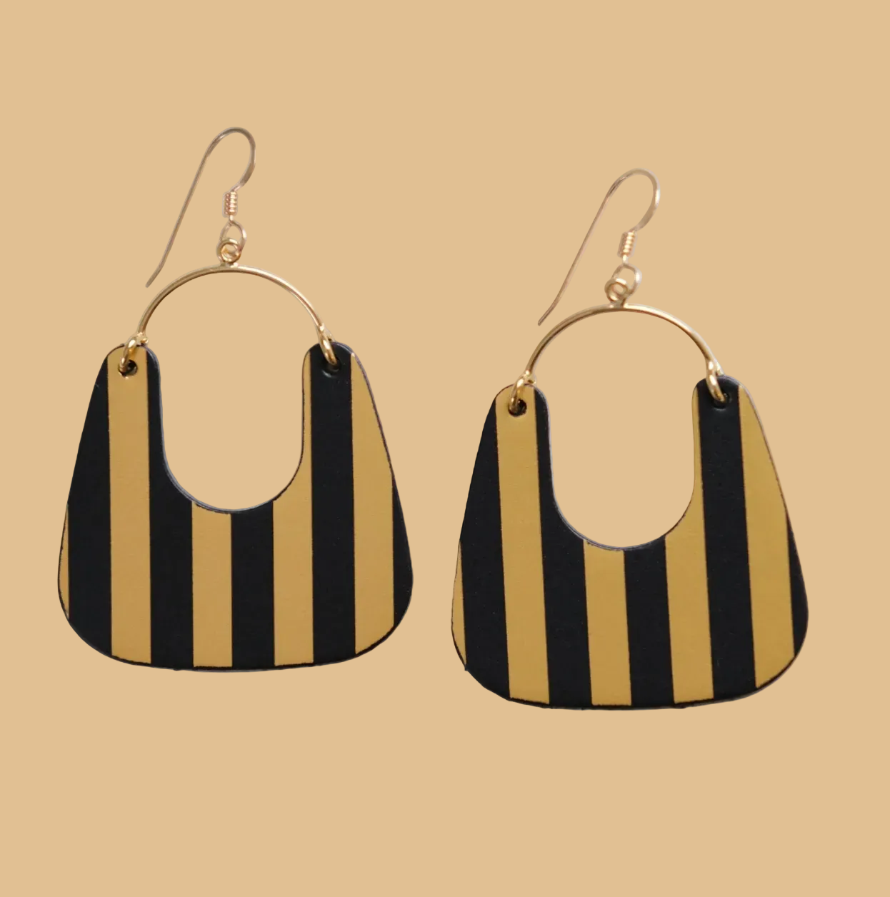Black and gold striped earrings on a light gray background