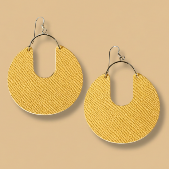 Pair of yellow earrings with white centers on a white background
