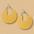 Pair of yellow earrings with white centers on a white background