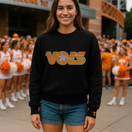 Person wearing a black sweatshirt with &