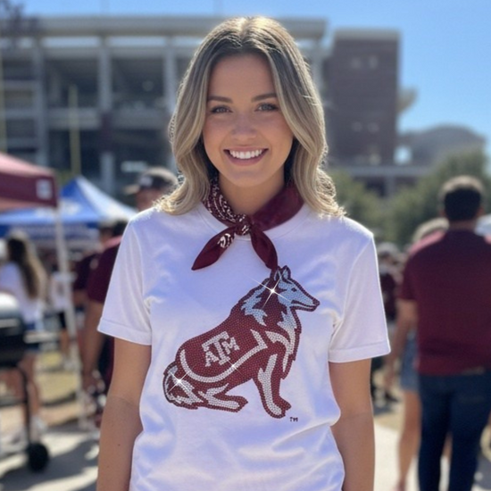 Woman wearing a white t-shirt with a logo and a red and white striped skirt outdoors.