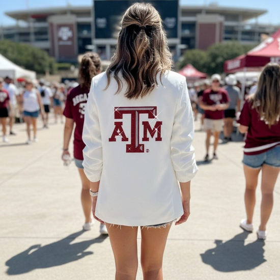 Person wearing a white sweatshirt with a red &