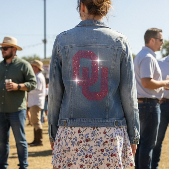 Person wearing a denim jacket with &