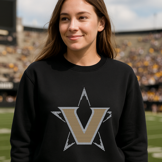 Person wearing a black sweatshirt with a star logo on a sports field