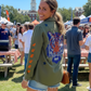 Woman wearing an Auburn University jacket with a tiger design at an outdoor event.