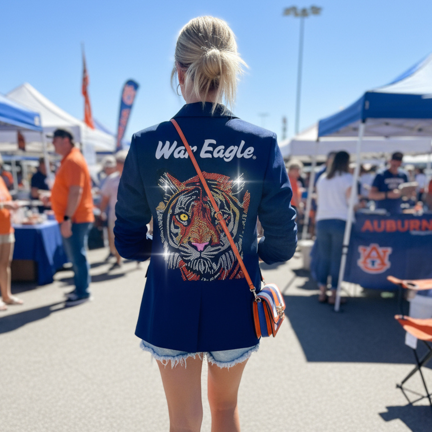 Person wearing a blue jacket with a tiger design and &