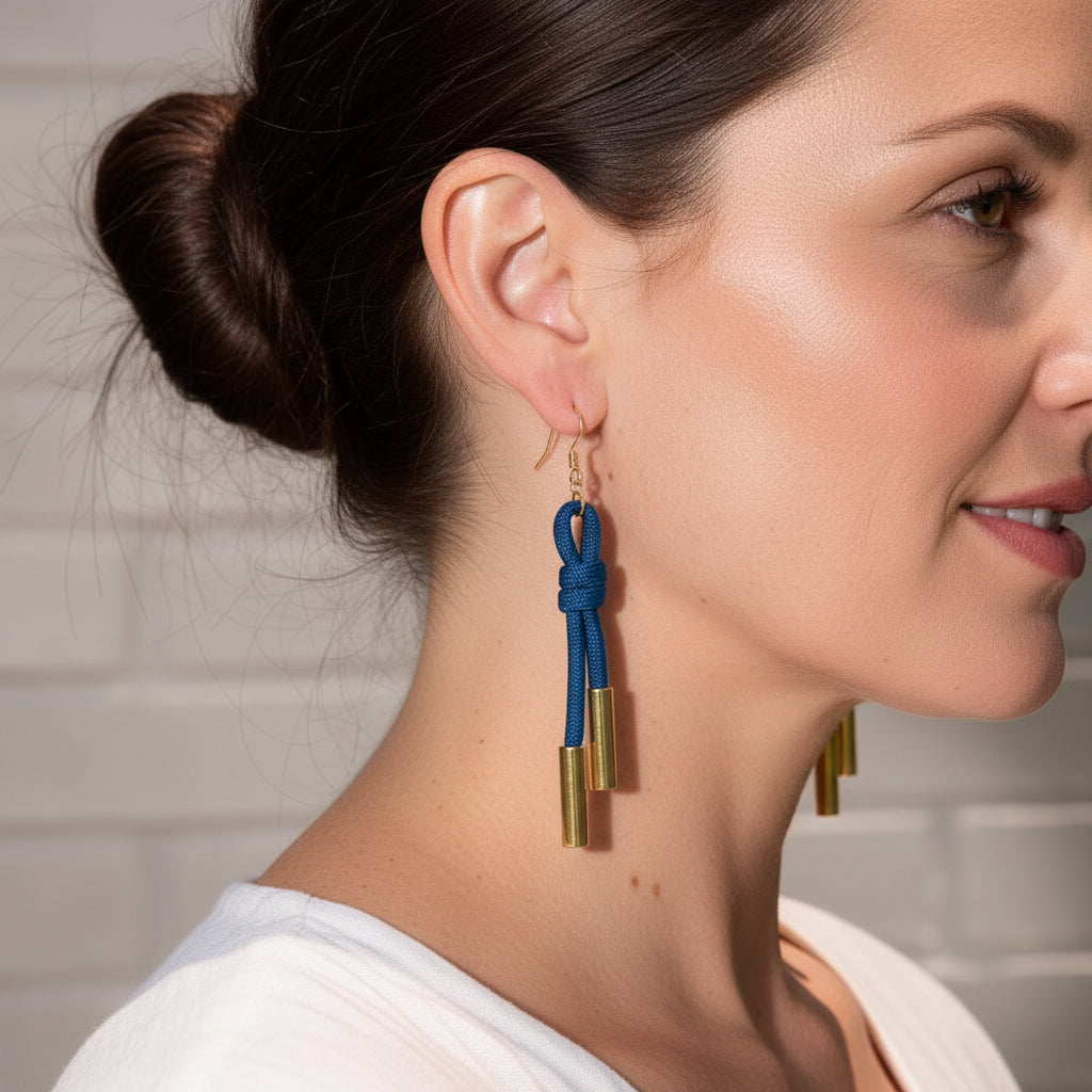 Close-up of a woman wearing blue and gold earrings.