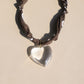 Necklace with a heart-shaped pendant on a beige background