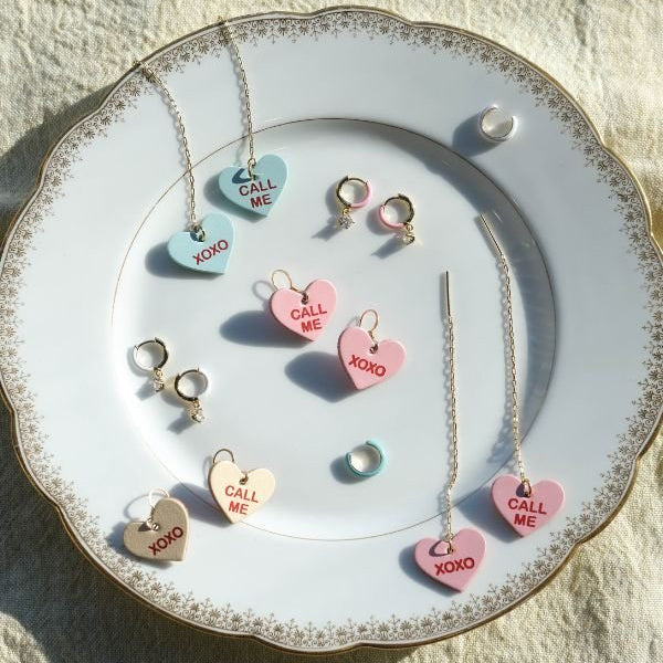 Jewelry set with heart-shaped pendants on a decorative plate