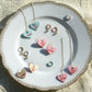Jewelry set with heart-shaped pendants on a decorative plate