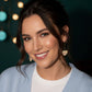Woman wearing heart-shaped earrings with &