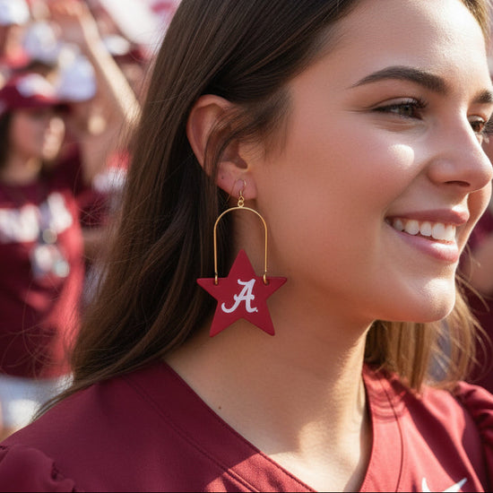 Red star-shaped earrings with a white &