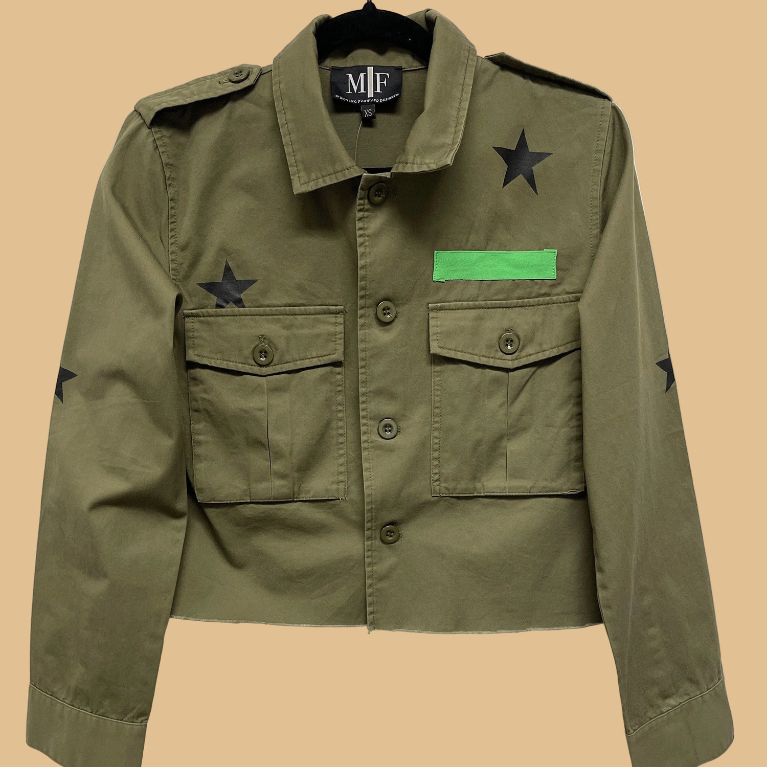 Green jacket with star and patch details on a white background