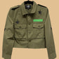 Green jacket with star and patch details on a white background