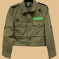 Green jacket with star and patch details on a white background