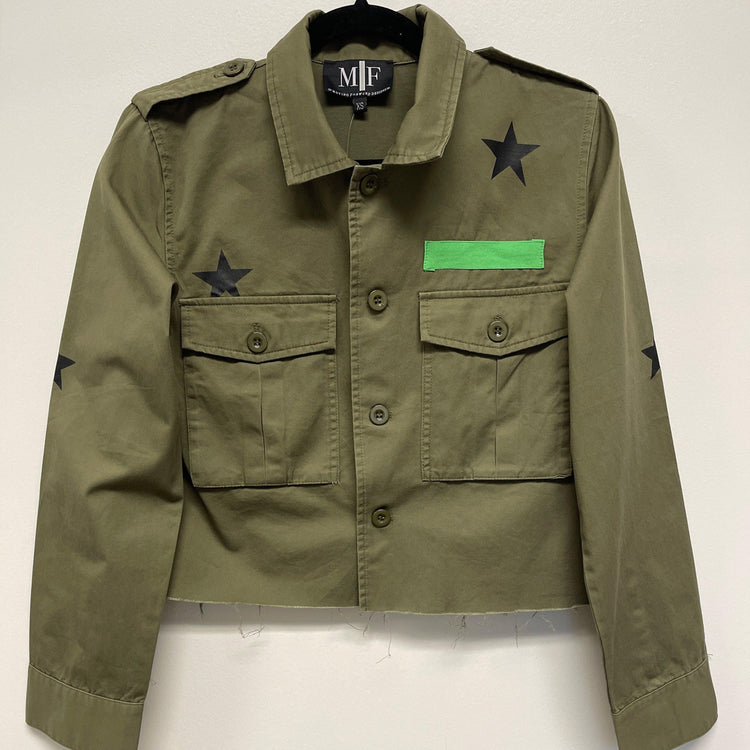 Green jacket with star and patch details on a white background
