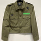Green jacket with star and patch details on a white background