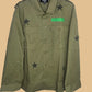 Green jacket with star patterns and a green patch on a white background