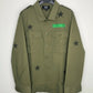 Green jacket with star patterns and a green patch on a white background