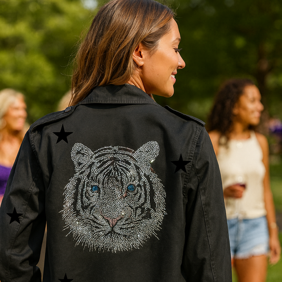 Woman wearing a black jacket with a tiger design outdoors