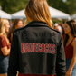 Person wearing a black jacket with &