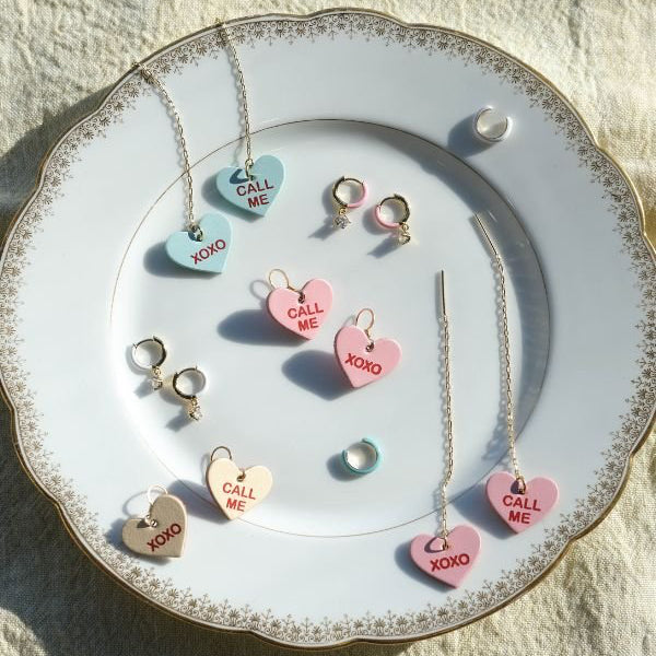 Jewelry set with heart-shaped pendants on a decorative plate