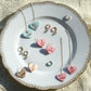 Jewelry set with heart-shaped pendants on a decorative plate