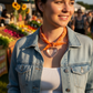 Orange bandana with heart-shaped metal charm on a beige background