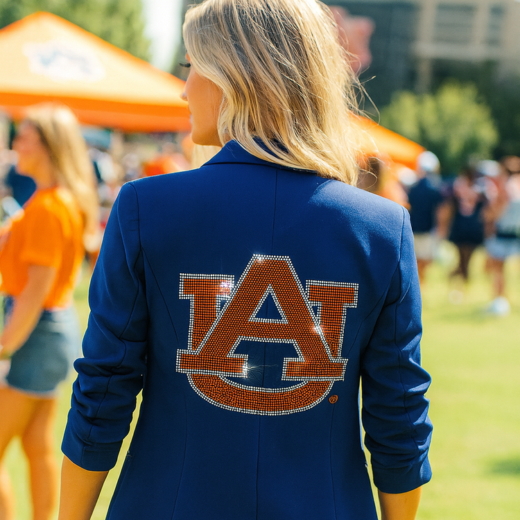 Person wearing a blue jacket with an Auburn logo outdoors