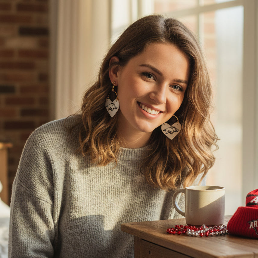 Heart-shaped earrings with a pig design on a beige background