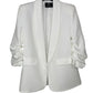 White blazer on a hanger with a visible brand label against a white background