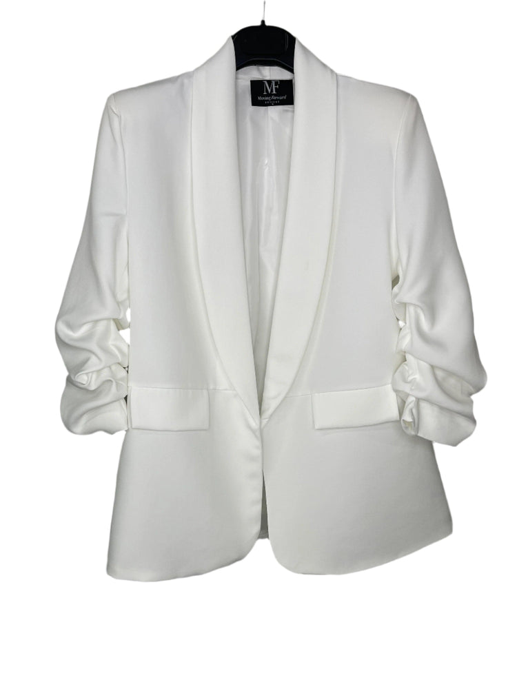White blazer on a hanger with a visible brand label against a white background